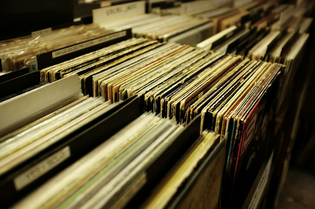 Rows of old filing cabinets and bound archive folders in a records room